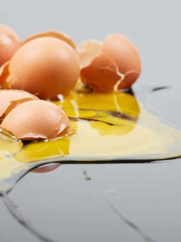 messy broken raw eggs spilled on kitchen counter