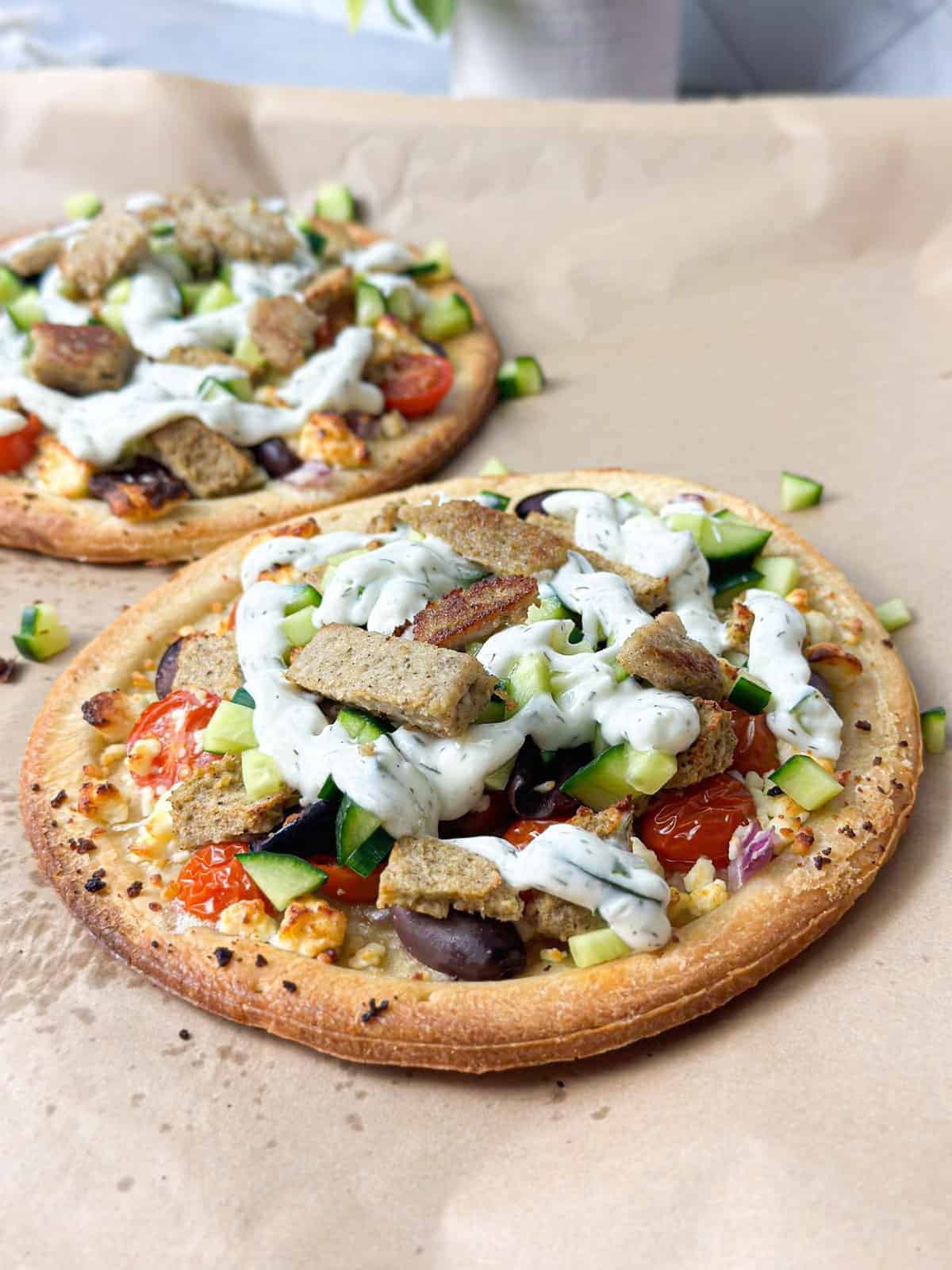 amazing baked flat bread filled to bursting with cucumber, cherry tomatoes, feta cheese, gyro meat, and tzatziki sauce