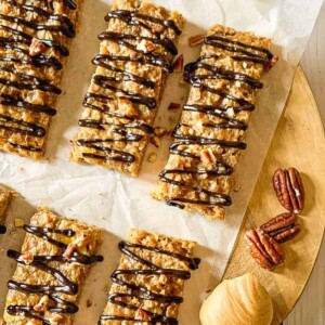 A top view of baked oatmeal bars drizzled with chocolate sauce