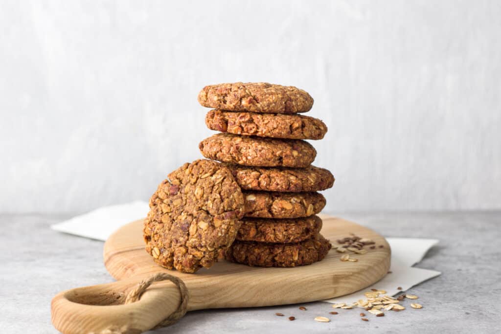 healthy delicious homemade oatmeal cookies on a wooden board on a gray textured background