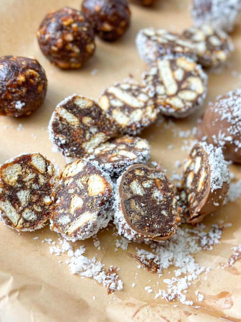 Date balls with chocolate and coconut in top and cut in half.