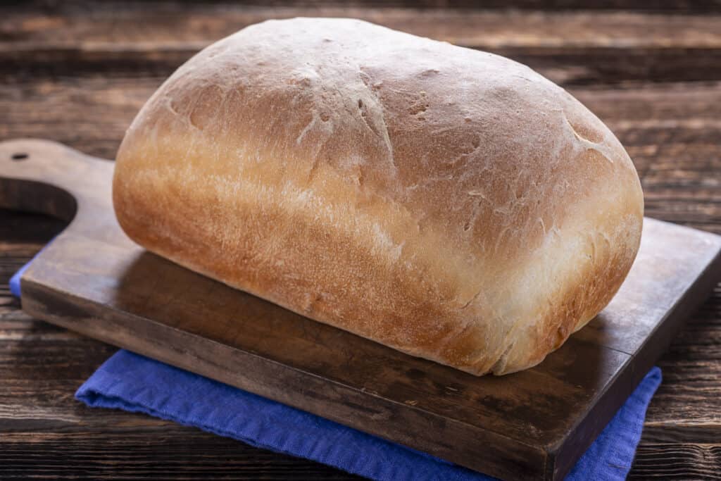 A fluffy, golden brown loaf of bread made with the ten minute dough