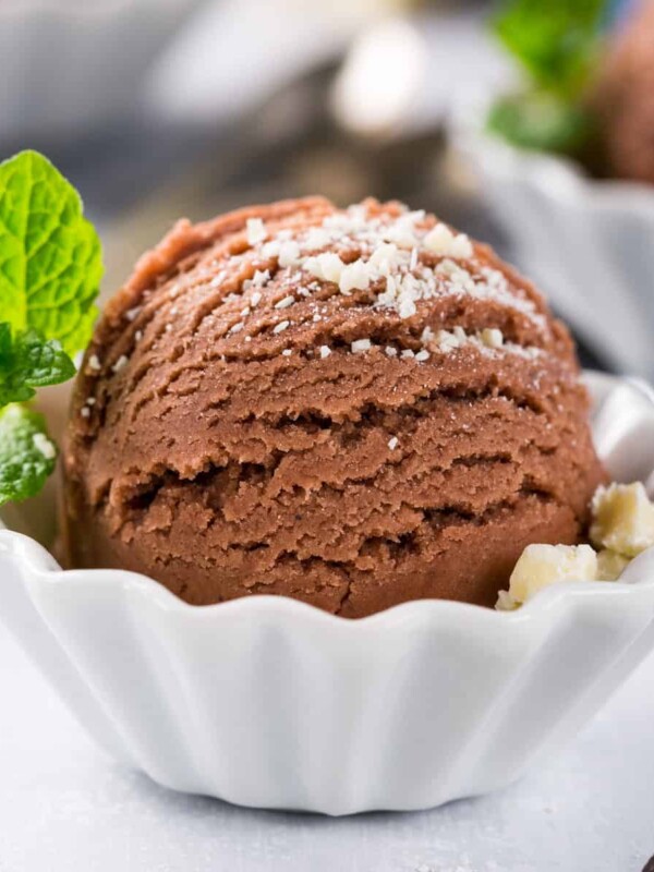 A scoop of Nutella ice cream with mint leaves.