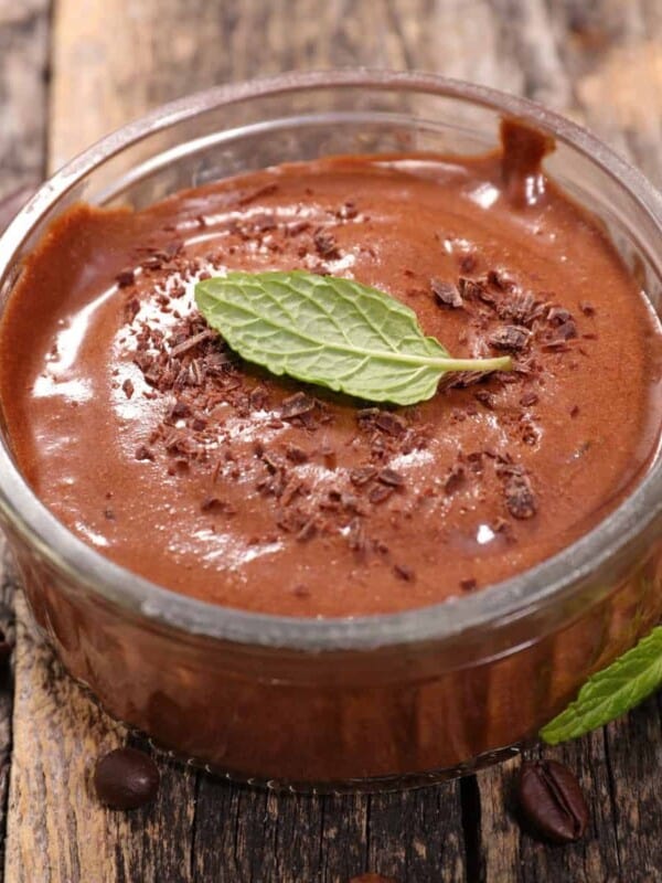 A bowl of homemade no-bake chocolate mousse served with fresh mint leaves.