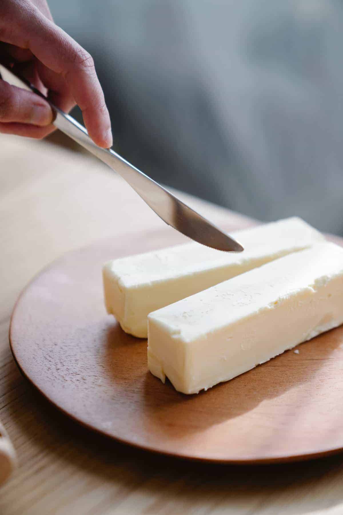 two blocks of butter placed on a wooden board