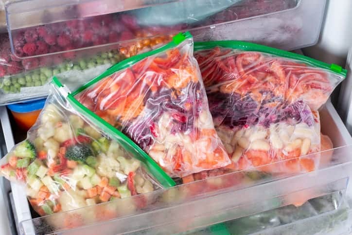 Frozen vegetables in a bag in the freezer. Long-term storage of products. Frozen food.