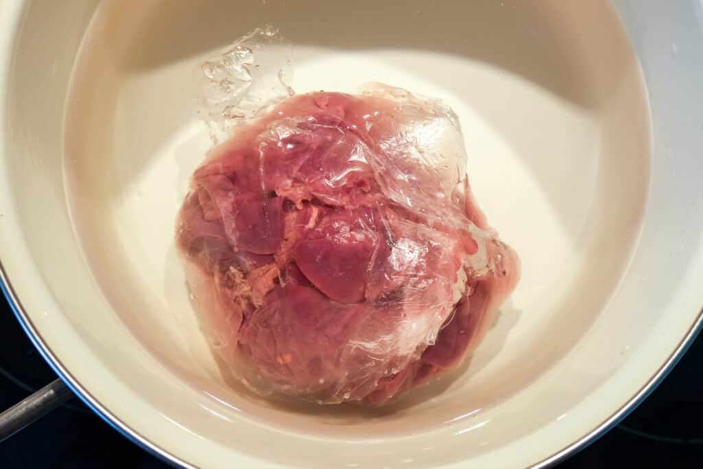 thawing meat in cold water