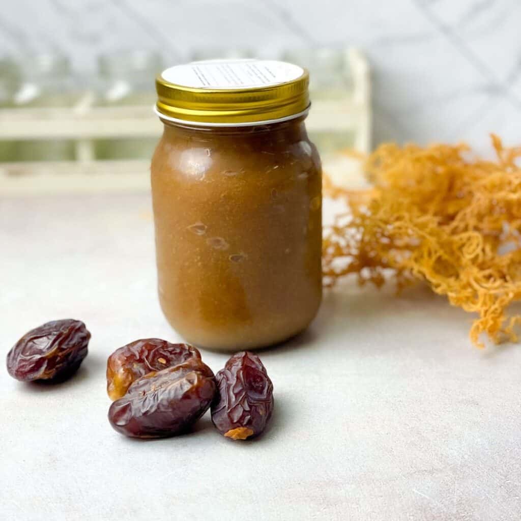a jar of sea moss gel with dates