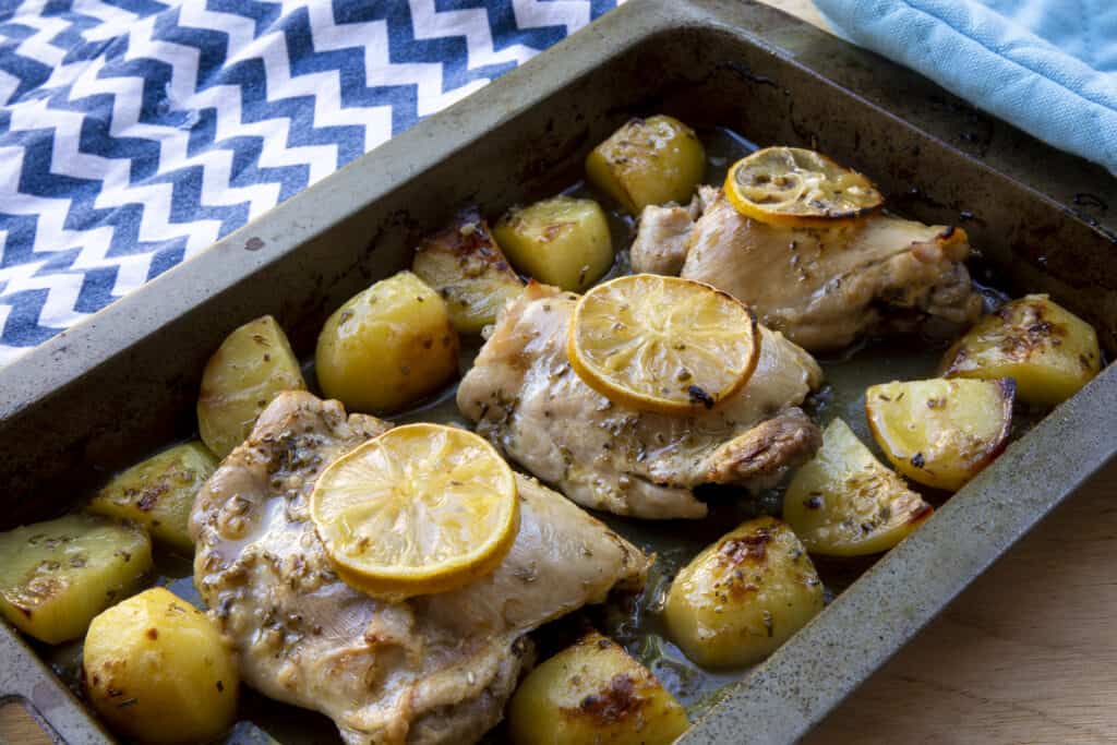 Oven baked Greek lemon chicken and potatoes with fresh herbs