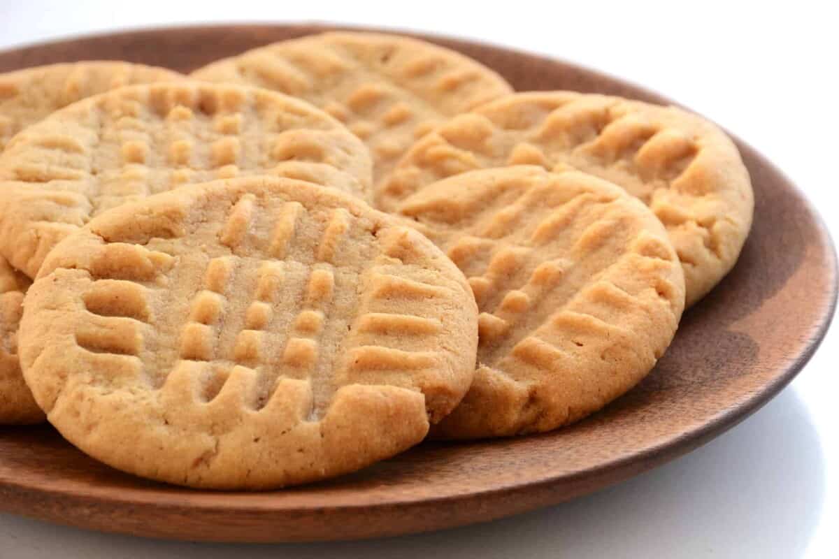 Creamy Peanut Butter Cookies Fresh baked peanut butter cookies on wooden plate shot in natural light with shallow depth of field