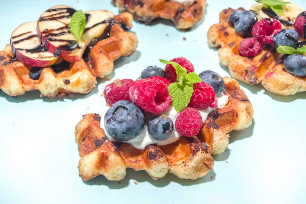 Golden Puff Pastry Waffles topped with whipped cream and yummy fruits such as blackberries and raspberries. Others are topped with apples and chocolate sauce. 
