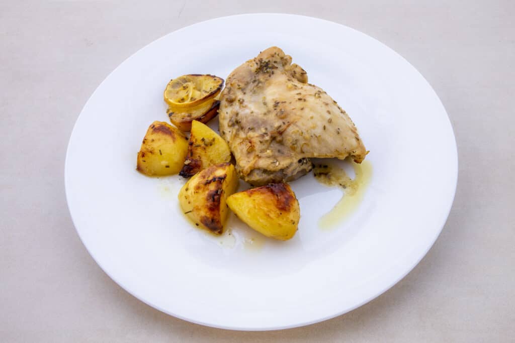 A plate of tender lemon chicken thighs and russet potatoes