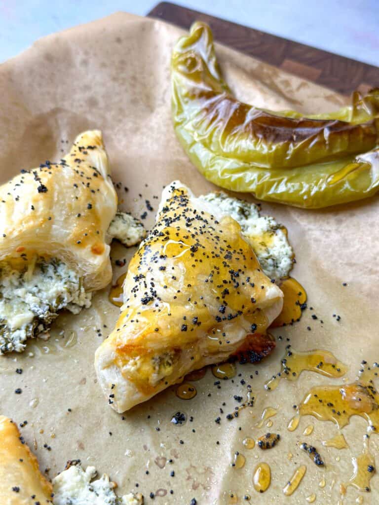 puff pastry triangles stuffed with feta cheese and new mexico peppers drizzled with honey