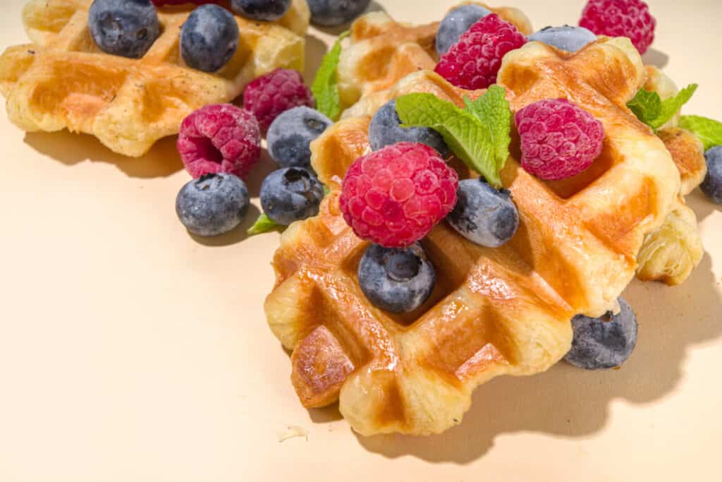Golden Puff Pastry Waffles topped with whipped cream and yummy fruits such as blackberries and raspberries. 