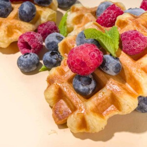 Golden Puff Pastry Waffles topped with whipped cream and yummy fruits such as blackberries and raspberries.