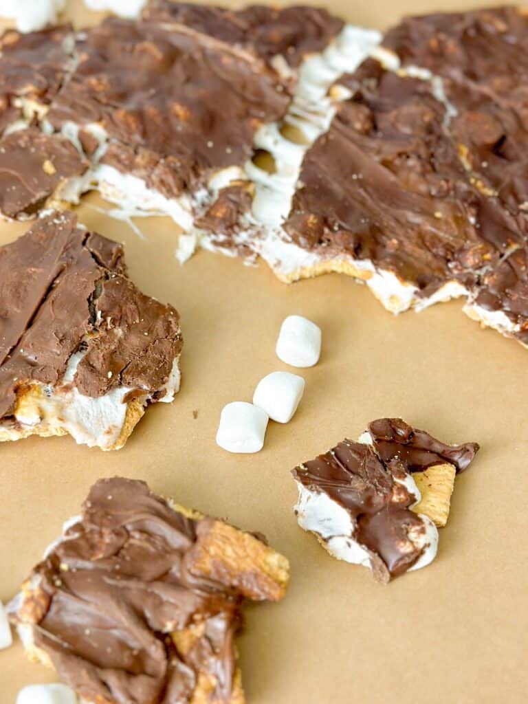 Breaking the S'mores Bark into pieces to be served or stored