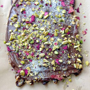 Velvety dark chocolate and peanut butter covering Medjool dates, garnished with crushed pistachios, rose petals and shredded coconut.