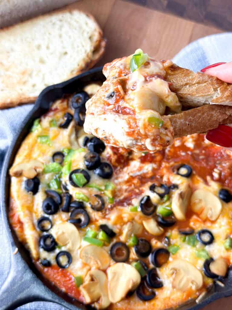 A pan of delicious pizza topped with black olives, green peppers and  mushrooms. 