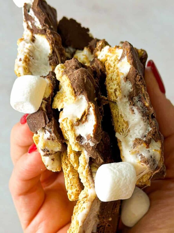 A chunk of smores bark with whole marshmallows, chocolate layer, and crunchy graham crackers.