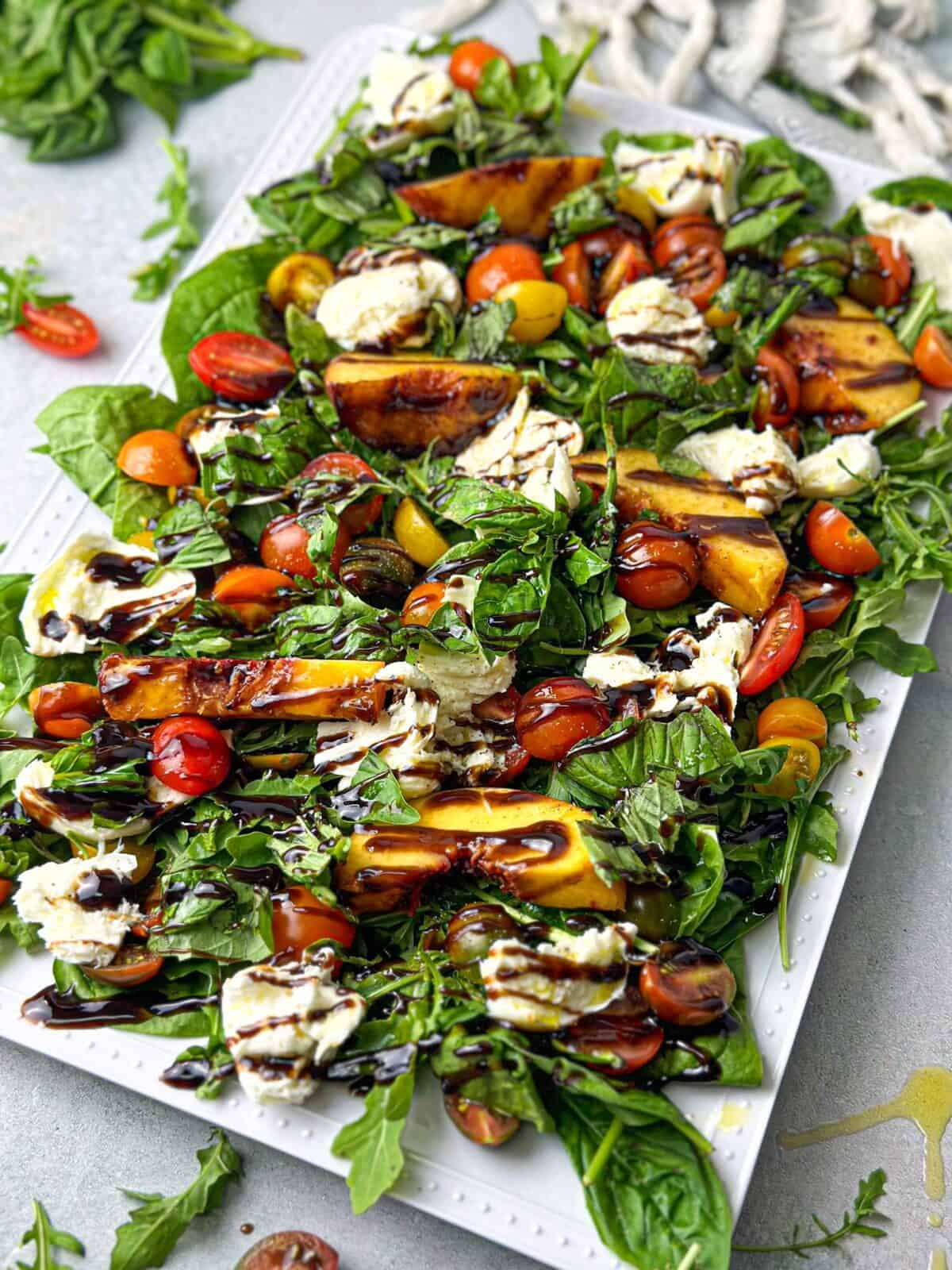 peach arugula burrata salad with baby spinach and cherry tomatoes