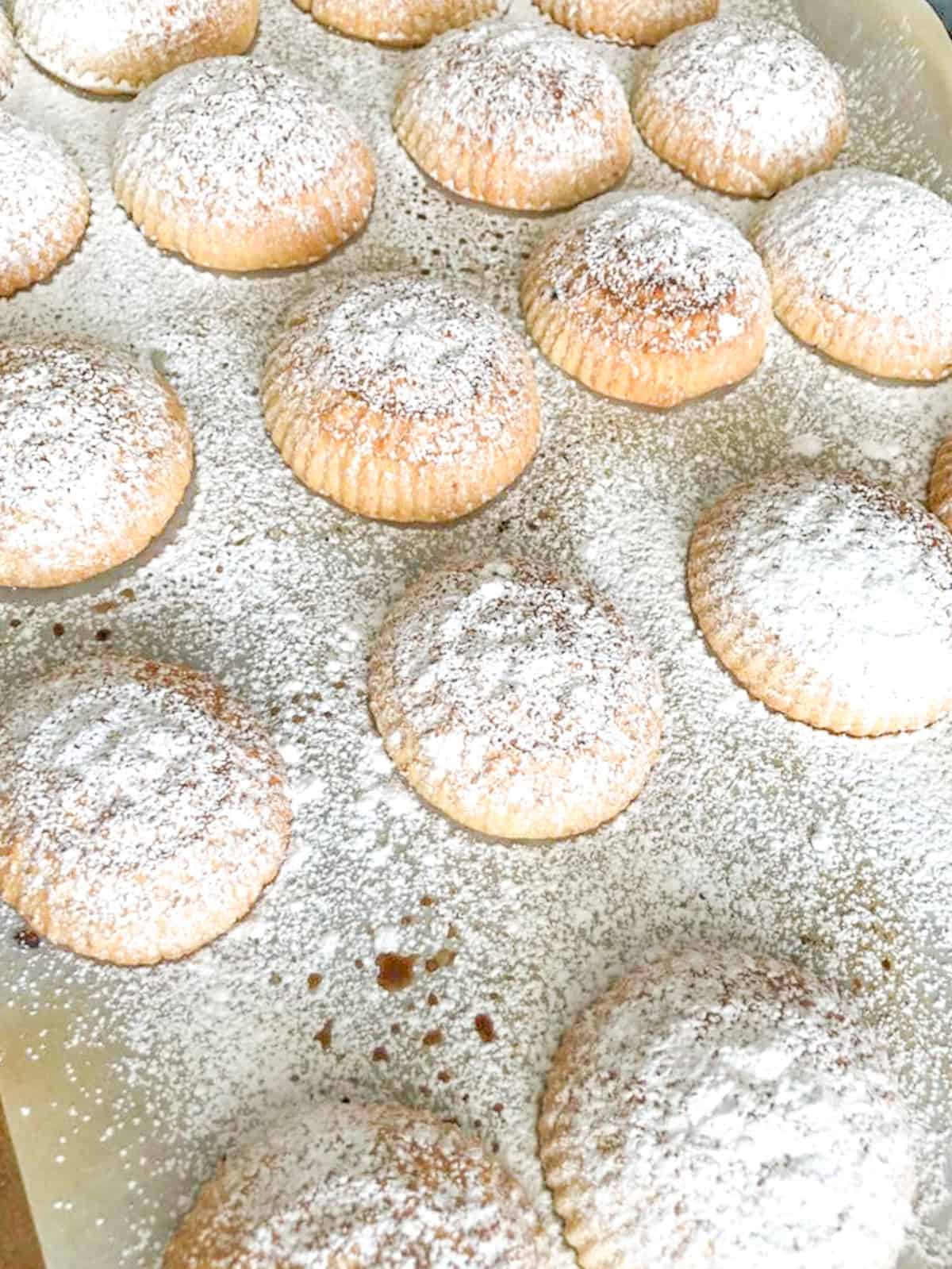 Lebanese Maamoul cookies filled with pistachios or date and topped with powdered sugar.