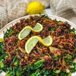 Kale Salad with Caramelized Onions topped with lemon wedges
