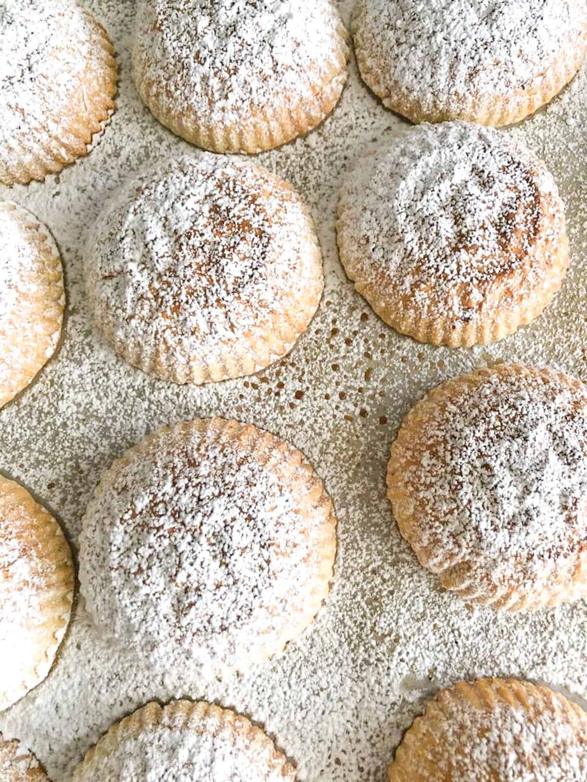 Lebanese Maamoul cookies filled with pistachios and topped with powdered sugar.