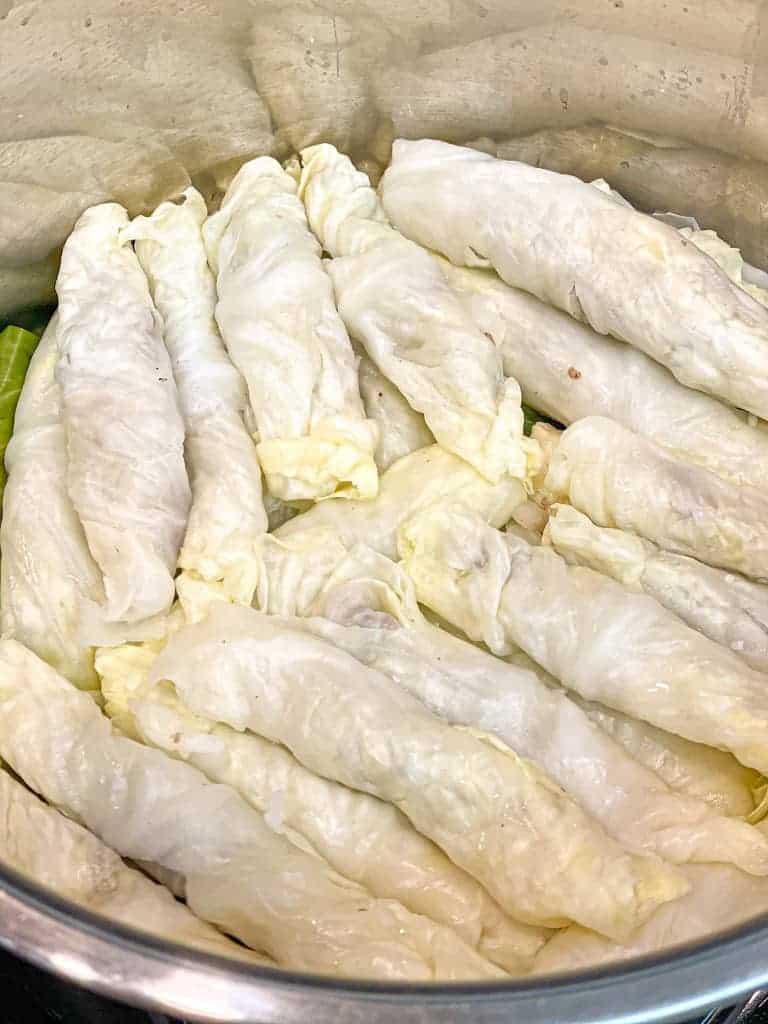 the rolled or stuffed cabbage leaves stacked in a pot without the broth