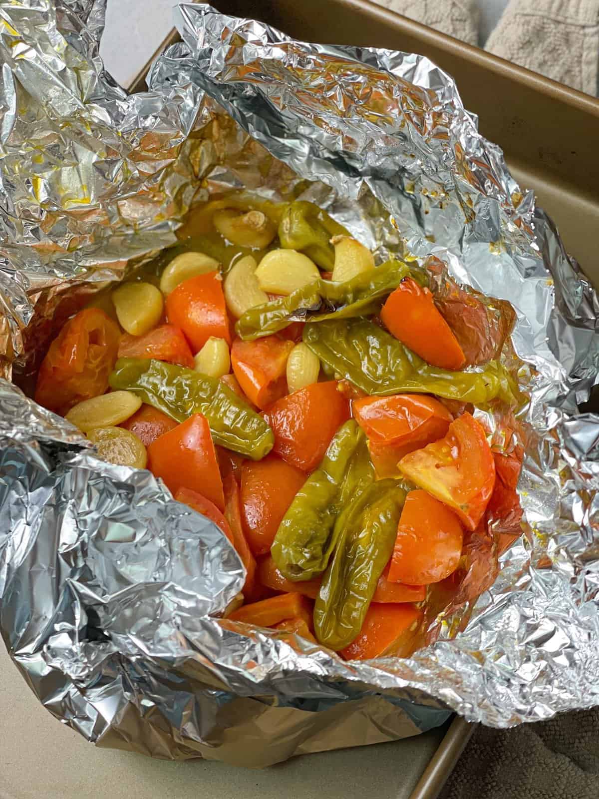 Roasted fresh vegetables in an aluminum foil.