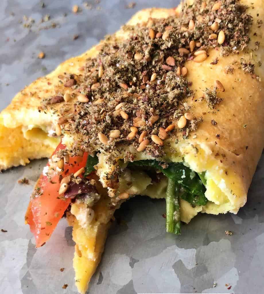 Fresh veggies and cheese wrapped up with homemade egg rolls topped with zaatar.