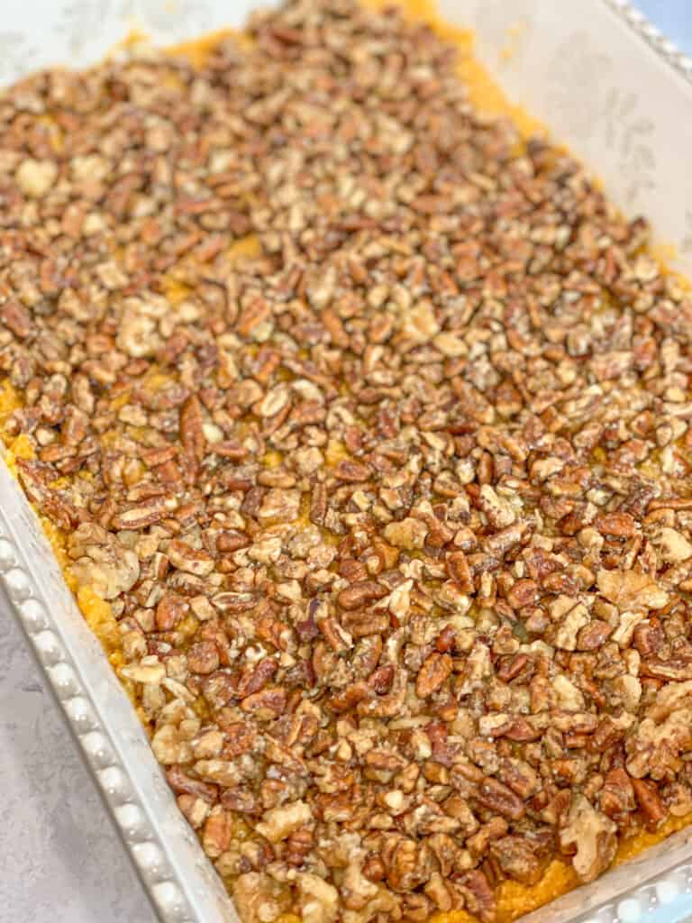 sweet potato bake casserole topped with toasted pecans