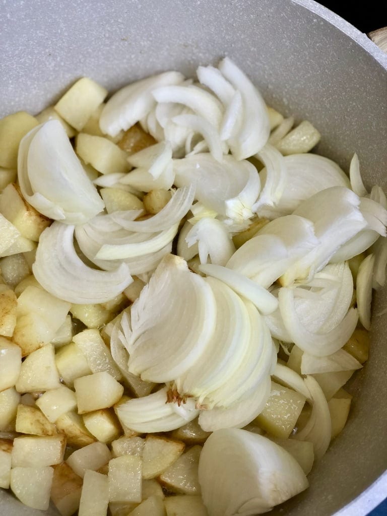 Sliced onions on top of grilled potatoes.