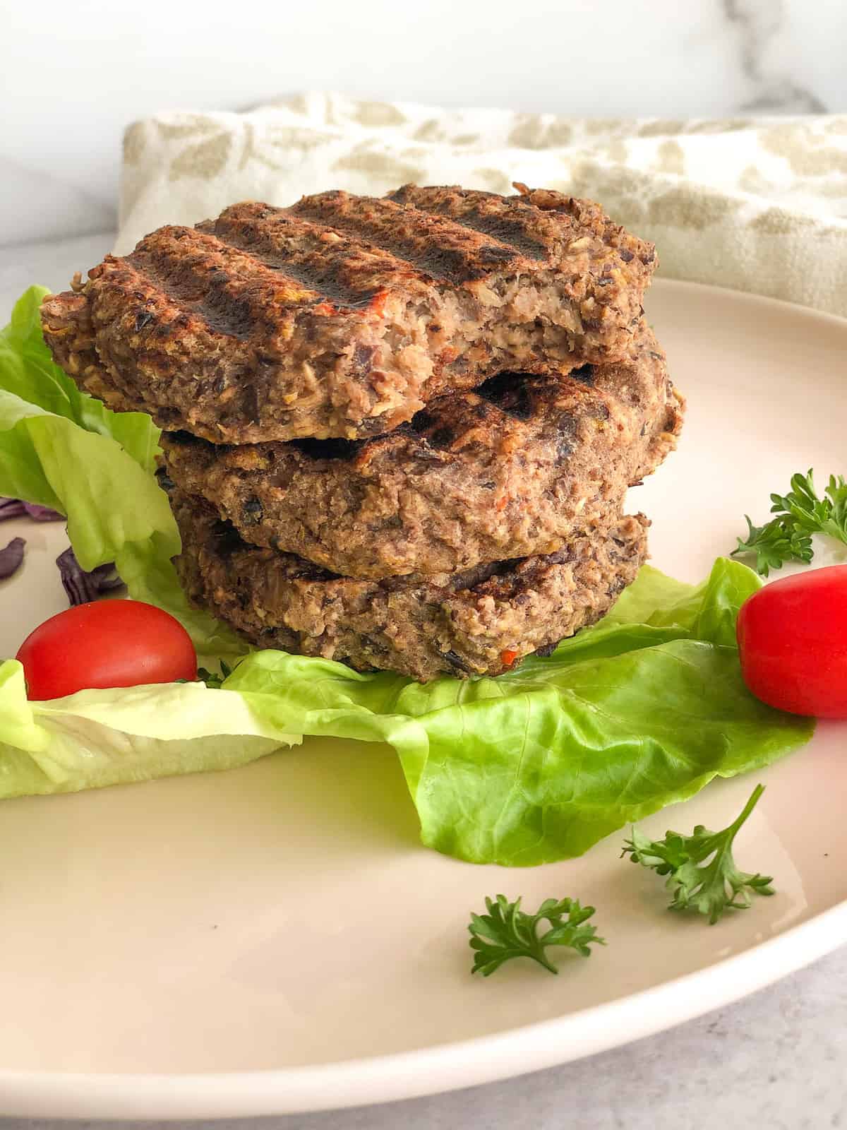 Chunks of black bean burger pieces with lettuce and tomato.
