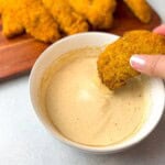 A creamy, tangy homemade sauce in a small bowl, perfect for dipping chicken tenders or fries. This copycat recipe replicates Raising Cane's signature sauce, known for its unique blend of flavors.