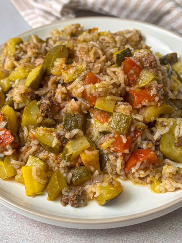 a close up image of rice and squash pilaf