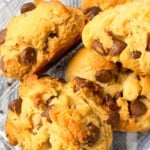 A bunch of thick cookies with chocolate chips.