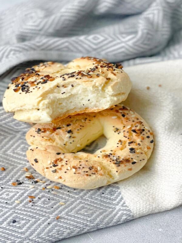 Freshly baked gluten-free bagels on a kitchen towel, golden and crisp