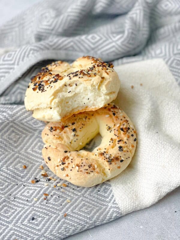 Freshly baked gluten-free bagels on a kitchen towel, golden and crisp