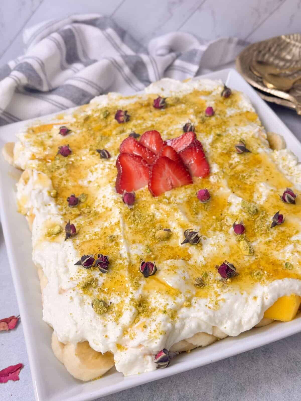no-bake fresh fruit cake with ashta cream served in a pan