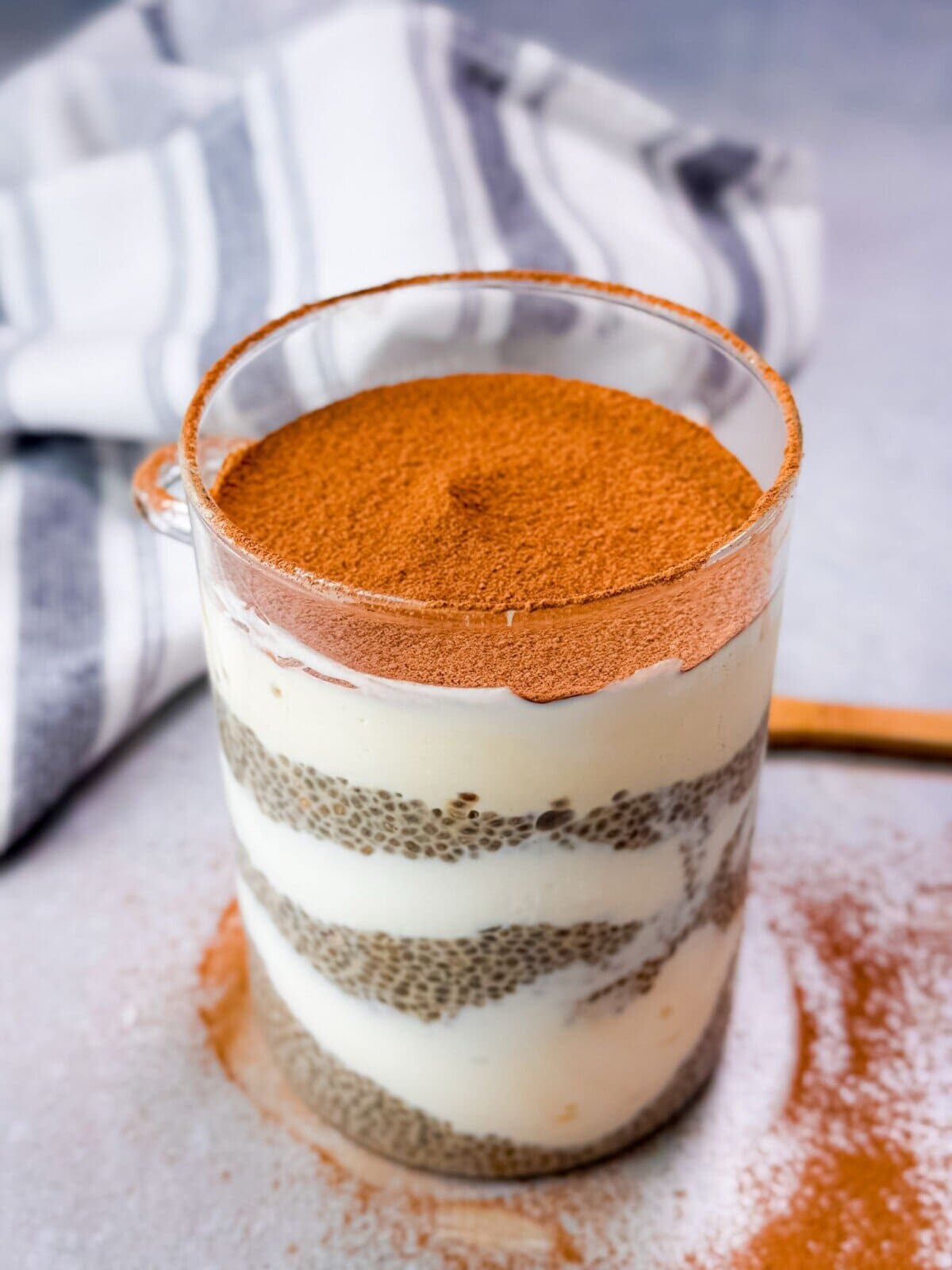 a glass filled with tiramisu chia seed pudding