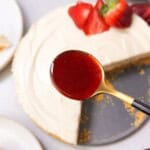 a top shot of a spoonful of strawberry rosemary sauce to be drizzled over no bake cheesecake
