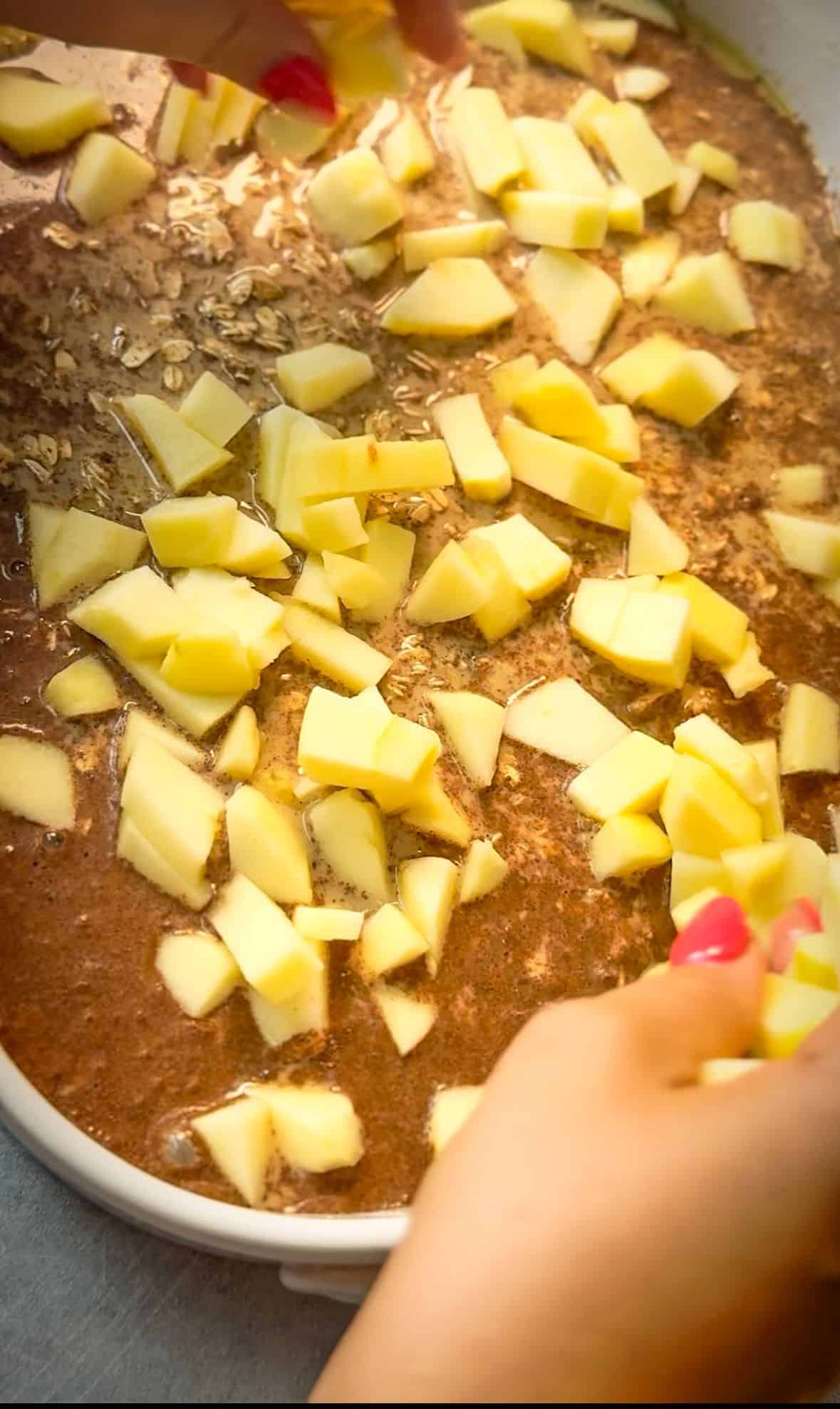 How to Make Apple Cinnamon Baked Oatmeal scatter diced apples on top of oatmeal mixture