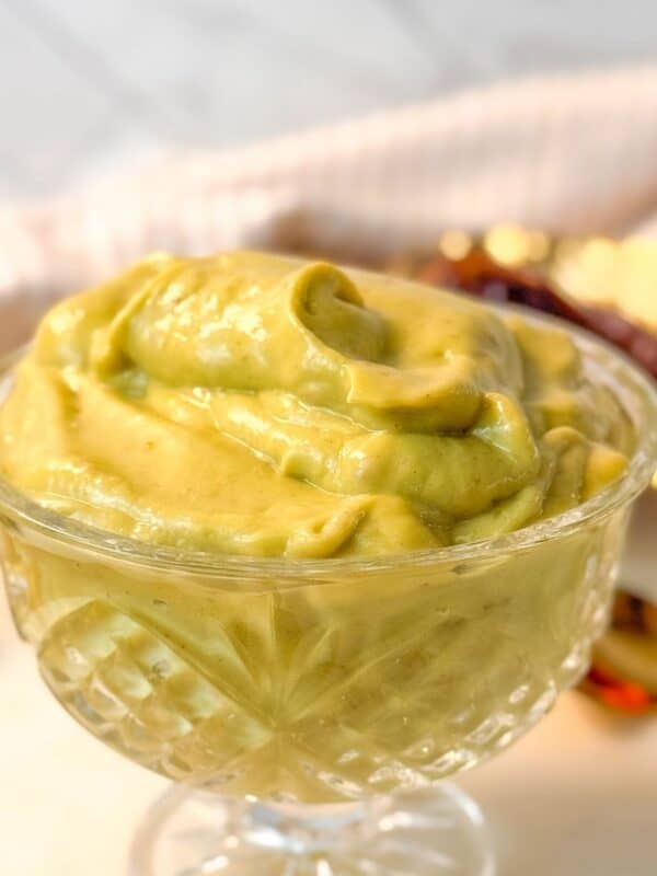 Close-up of a glass bowl filled with creamy avocado date pudding