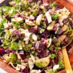 Close-up of colorful beet, cucumber, and feta salad tossed in vinaigrette.