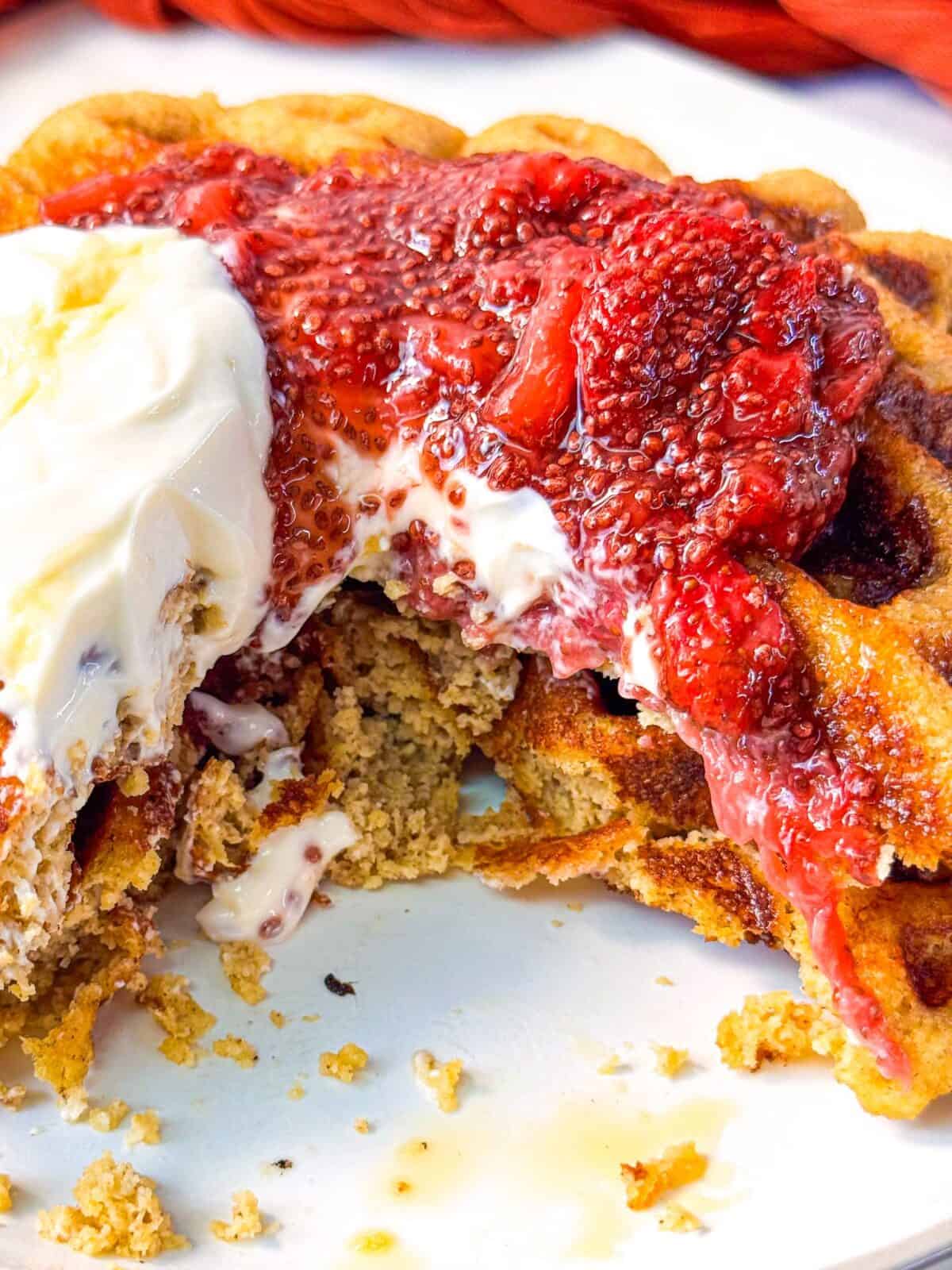 Best Strawberry Chia Jam waffles cut open and topped with creamy yogurt and strawberry chia jam
