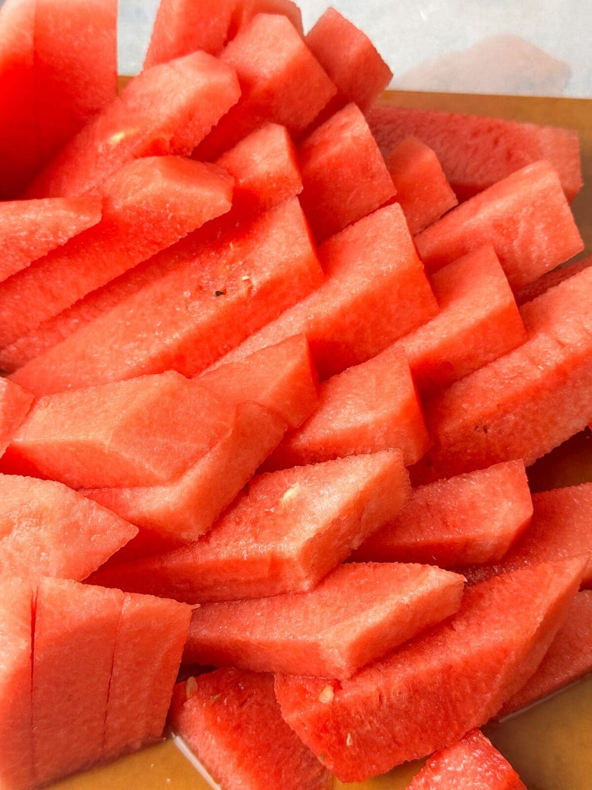 Bite-Sized Watermelon Sticks juicy, refreshing watermelon sticks on a cutting board