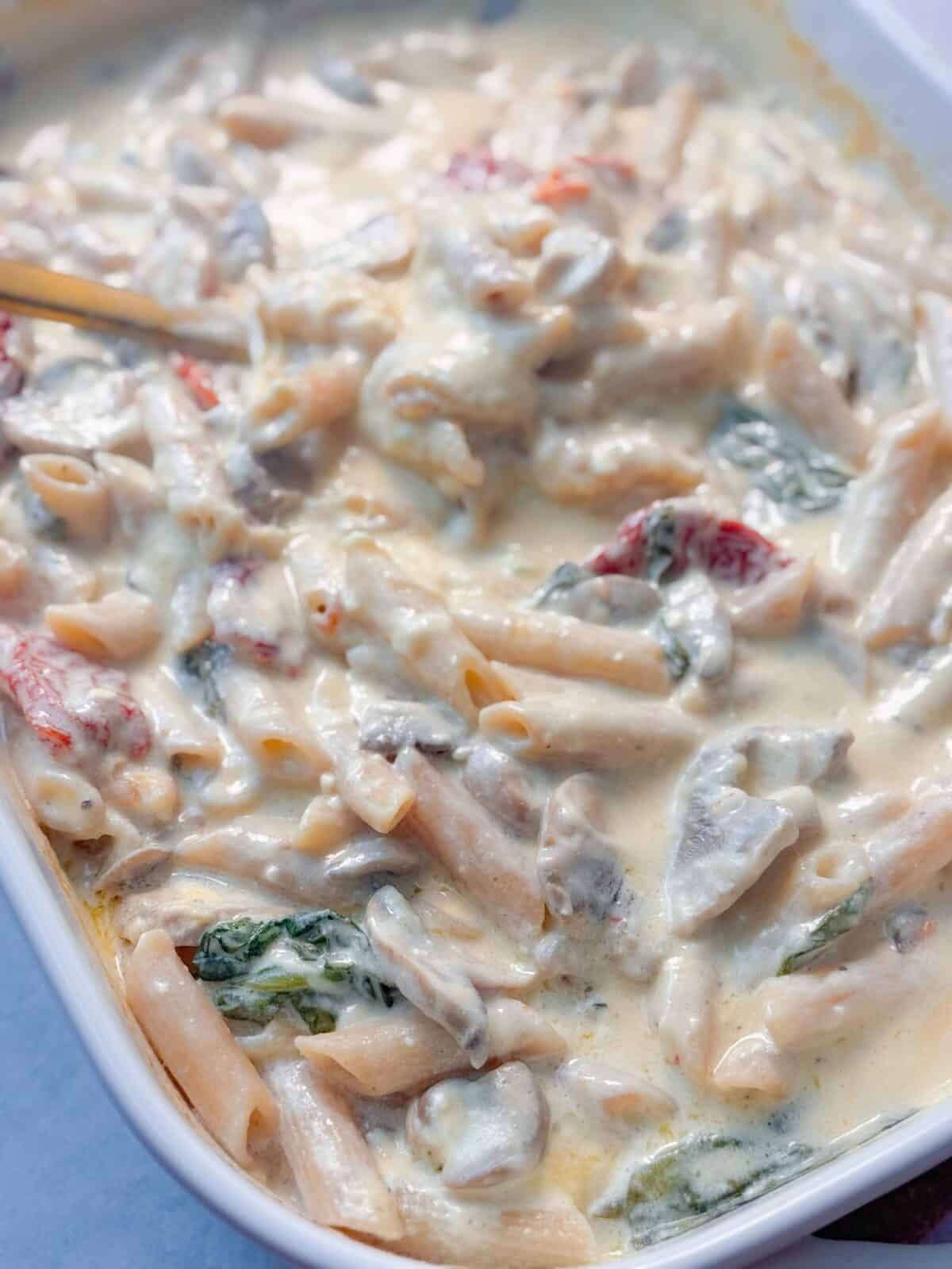 Creamy Pasta Bake Creamy pasta bake with penne, mushrooms, spinach, and sun-dried tomatoes stirred together.
