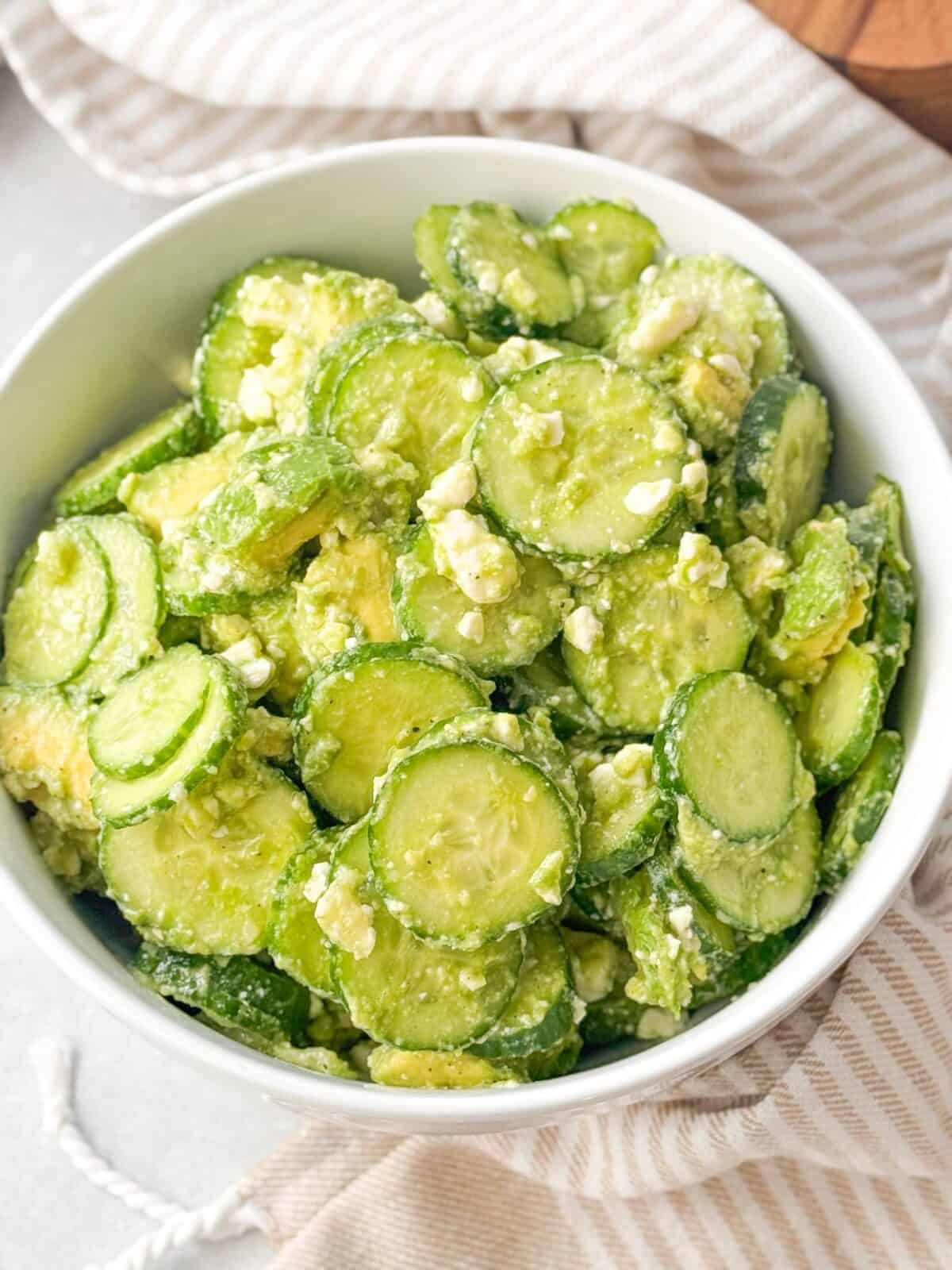 Easy Cucumber Feta Salad top shot of fresh cucumber feta salad served in a white bowl