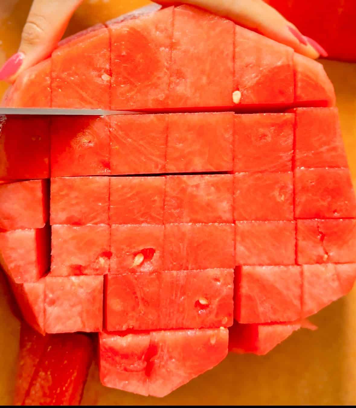 Turn the watermelon 90 degrees. Slice again, this time about 1 inch apart, to create long stick-like pieces.