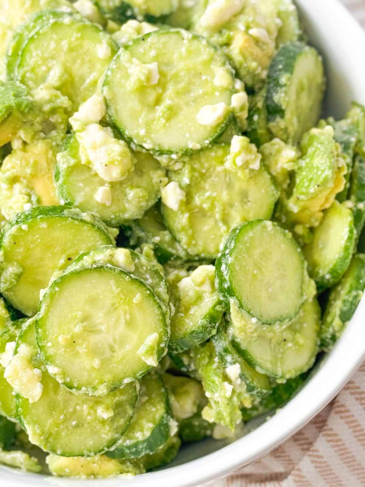 Feta Cucumber Avocado Salad Close-up shot of cucumber salad with feta cheese and herbs, a fresh and healthy summer side dish.